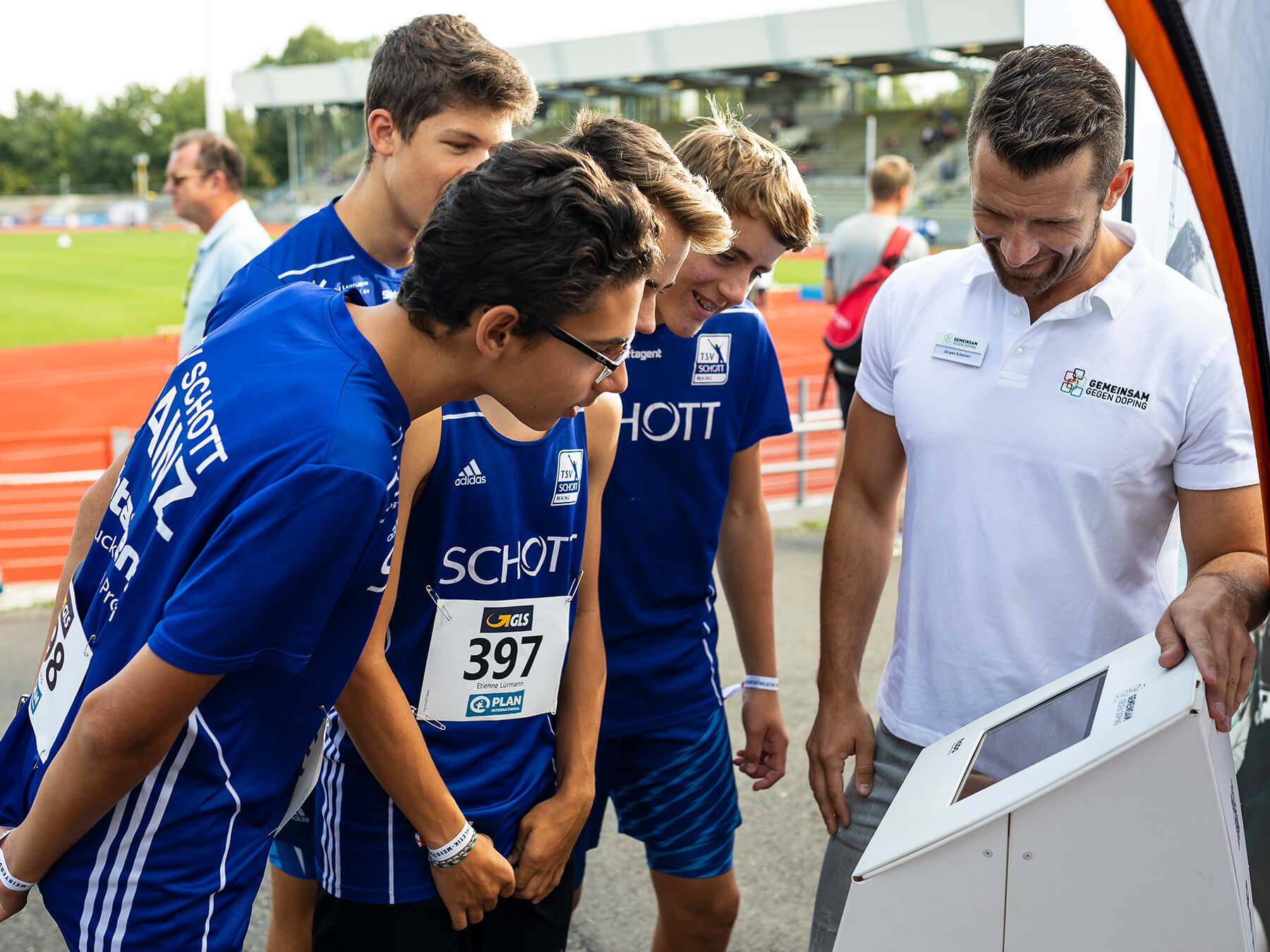 Young athletes stand at the booth in front of the quiz