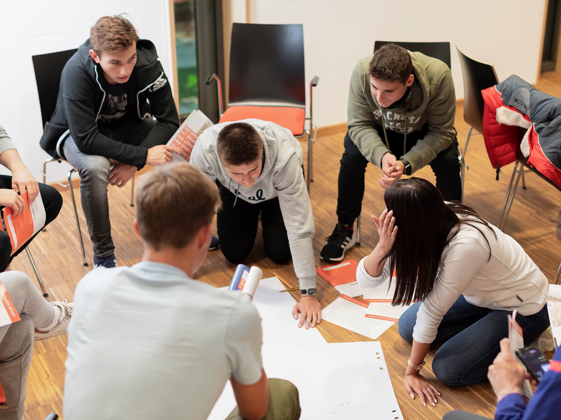 Group working on a poster on the floor